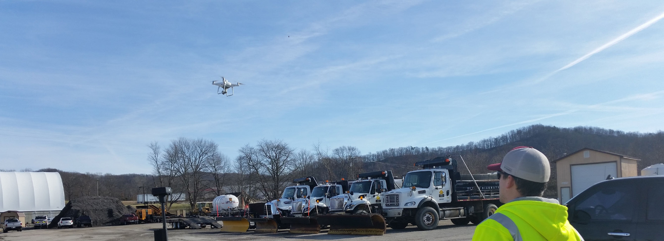 A drone in flight over a maintenance facility