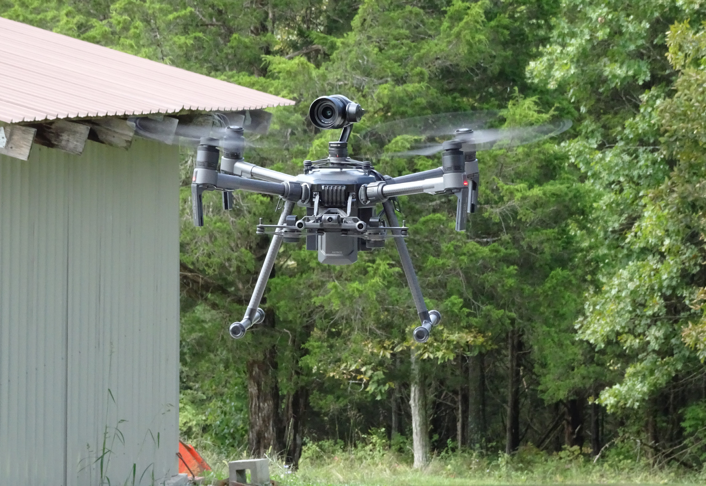 A photo of a drone in a wooded area