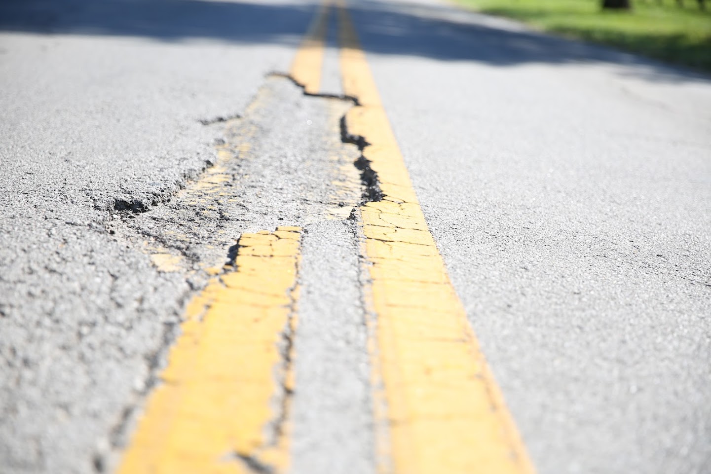 photo of cracked double yellow line roadway paint