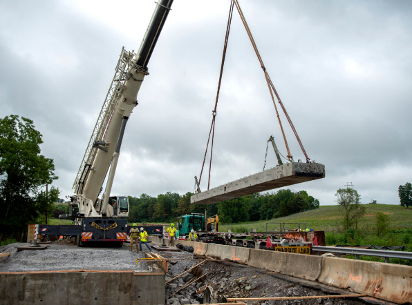 a crane lifting a bridge section