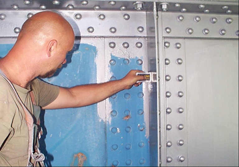 Figure 58 Man inspecting film thickness